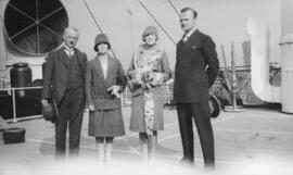 [Four people aboard a ship]