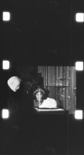 [Lloyd George viewing a death mask]