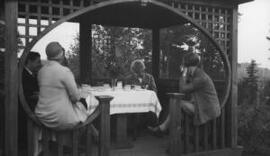[David Lloyd George, Frances Stevenson and others sitting in a gazebo]