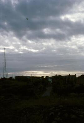 [Silhouetted roofs, late evening]